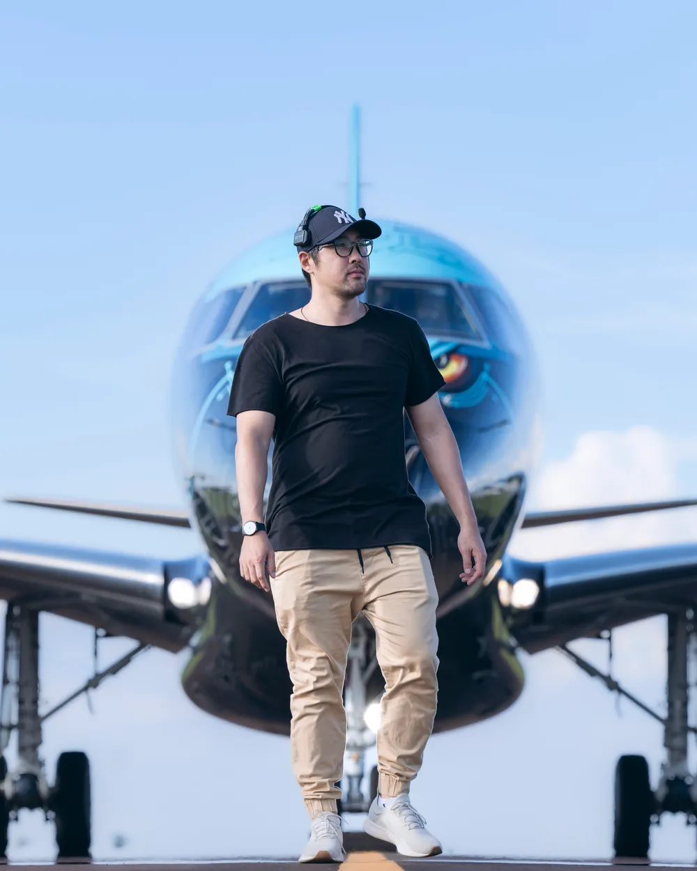 Shindi Kavamukai on the runway in front of an Embraer E2 jet